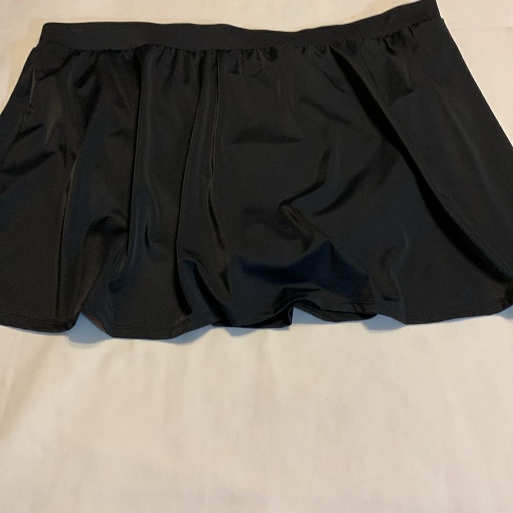 Size 26W one piece black swim skirt with built in panty. NEW